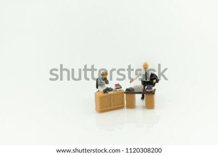 Miniature people: Manager and secretary sitting on chair with copy space using as background business concept.