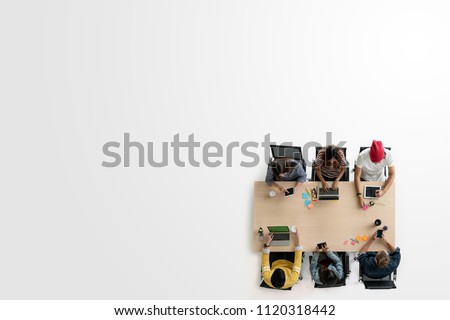 Top view of diverse people of creative team group using smartphone, tablet and computer laptop. Overhead of asian young creative start up meeting. Have copy space for fill text Royalty-Free Stock Photo #1120318442