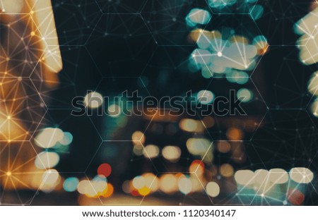Hexagon grid with blurred city abstract lights background