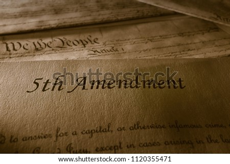 The 5th Amendment with US Constitution in the background                                Royalty-Free Stock Photo #1120355471