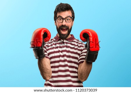 Happy Man with glasses with boxing gloves on colorful background