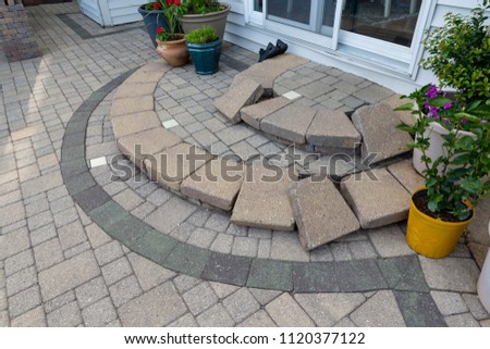 Replacing paving edging bricks on curved patio steps in front of the door to the house with them all laid neatly in position to commence work