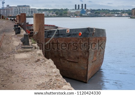 Old rusty ship moored in Canary Wharf, on the Isle of Dogs in London 