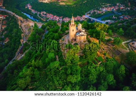 Aerial sunrise view of Tsarevets Fortress in Veliko Tarnovo in a beautiful summer day, Bulgaria 2018. Royalty-Free Stock Photo #1120426142
