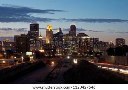 minneapolis skyline from 24th street pedestrian bridge overlooking 35w interstate and office towers of downtown in distance