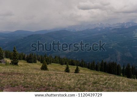 A stormy, landscape view of a mountain range seen from Vail, Colorado. 