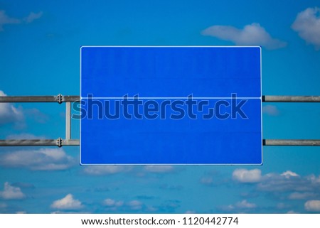 Big blank highway road sign with gradient blue sky.
