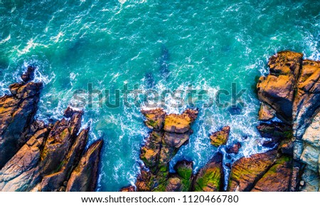 Are Aerial drone view above California beach near San Francisco Bay Area Pacific Ocean gorgeous landscape turquoise blue surf waves crashing along mountain coast