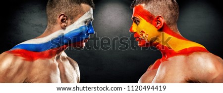 Russia vs Spain. Two soccer or football fans with flags face to face.