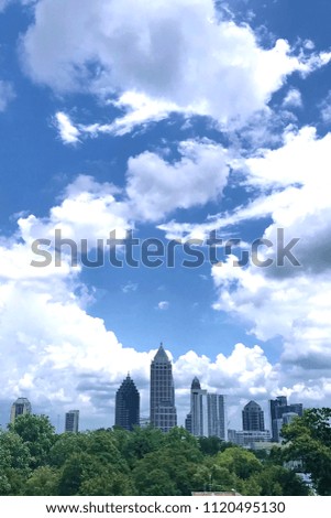 View on Atlanta skyscrapers in front of the blue sky with white clouds.