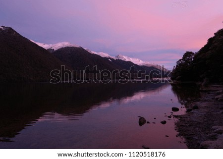                          Reflections of dawn over a calm lake    
