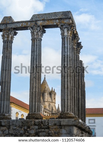 View of Evora Cathedral through the Roman temple columns, in Evora, Portugal.
