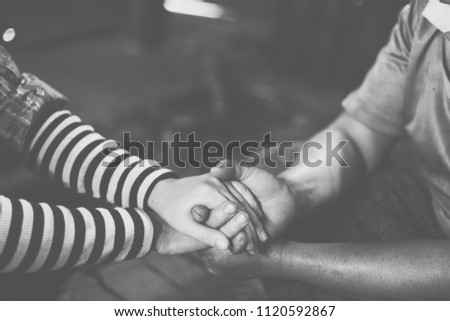 black and white Young hands holding old hands and pray together,Pray for the elderly concept.