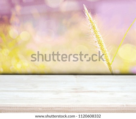 Wood table top on beautiful grass background in the morning. Sweet bokeh. Feel fresh. Double exposure. Can be use for display, montage, brochure or advertising. Copy space.
