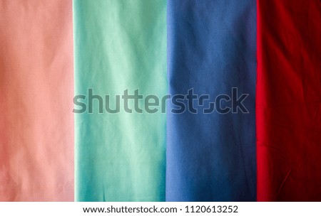 The color ful on clothes. Red, pink, blue and green clothes. 