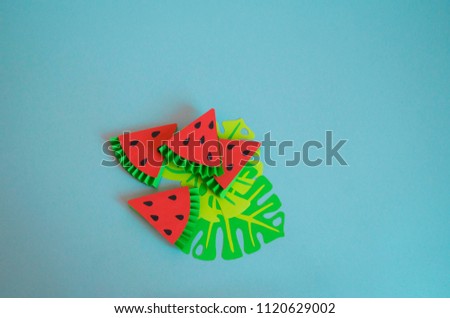 Fruits made from paper on a blue background. watermelon. View from above. Children's creativity. Tropical party of Hawaii.