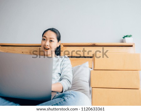 Online business owner Asian woman check her product stock in bedroom.