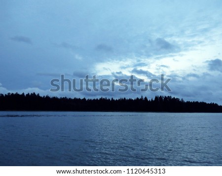 View at Panorama of Lake with Dark Storm Clouds on the Sky