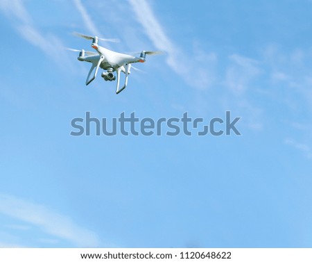 Drone flying on a clear sunny sky background 