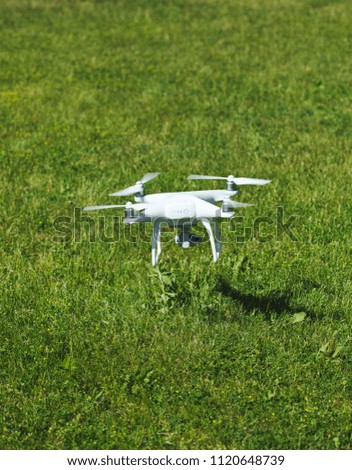 Drone flying on a green grass background