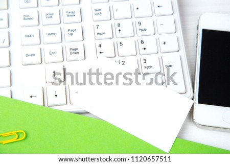 Business card on the office Desk with green paper and keyboard. Mockup