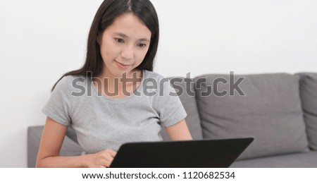 Woman working on notebook computer at home