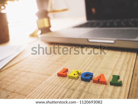 Lawyer object with text display on wooden table desk and laptop.