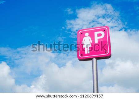 Lady parking sign over blue sky and clouds with copy space, blank for text.