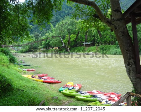 The kayaks of tourists are parking along The Song River in high season of Vang Vieng , LAO PDR.