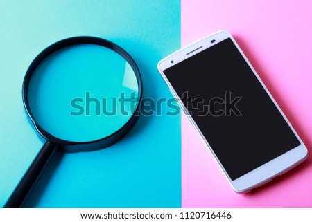Smartphone and magnifying glass