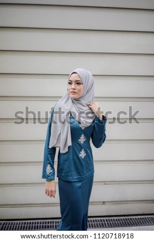 Portraiture of a beautiful young female model wearing hijab. Muslim female hijab fashion portraiture concept.