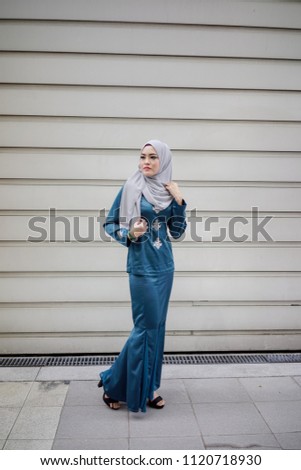 Portraiture of a beautiful young female model wearing hijab. Muslim female hijab fashion portraiture concept.
