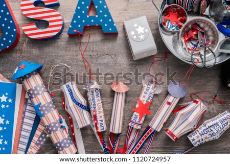 Paper firecrackers made from red, white and blue paper for July 4th celebration.