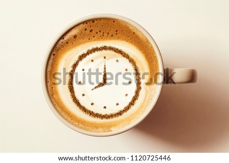 a cup of coffee cappuccino with a clock pattern from cinnamon on milk foam Royalty-Free Stock Photo #1120725446