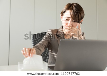 Young asian woman blowing her nose. Nasal inflammation. Hay fever. Royalty-Free Stock Photo #1120747763