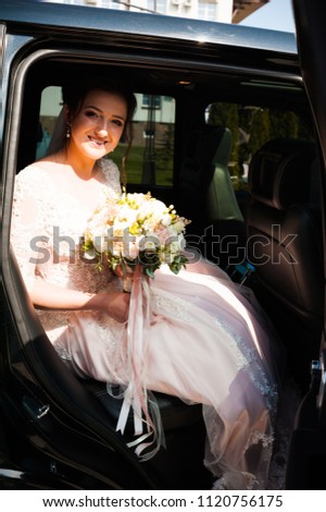 Beautiful bride in a car