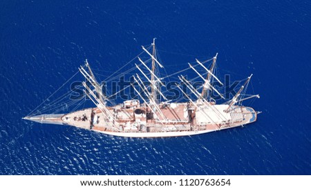 Aerial drone bird's eye view photo of classic sail yacht docked in deep blue Aegean island port