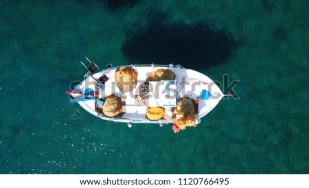Aerial drone bird's eye view photo of traditional fishing boat docked in picturesque fishing village of Faros, Sifnos island, Cyclades, Greece