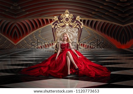 A woman in a luxurious gown dress sitting on a queen's throne Royalty-Free Stock Photo #1120773653