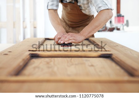 carpenter work the wood with the sandpaper Royalty-Free Stock Photo #1120775078