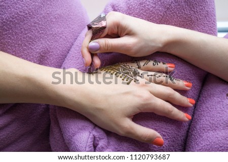 beauty concept - Picture of human hand being decorated with henna Tattoo. mehendi hand