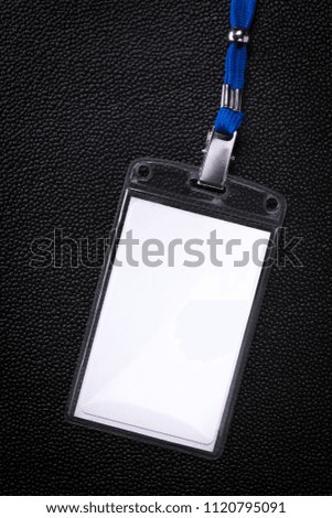 Hanging business card on dark background. Blank badge Identification card.