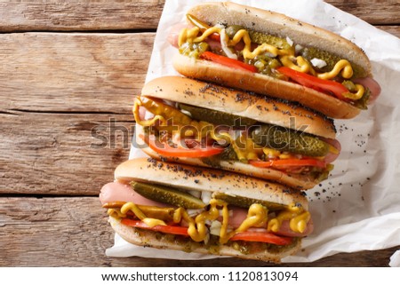 Traditional Chicago style hot dog with mustard, vegetables and sauce close-up on the table. Horizontal top view
 Royalty-Free Stock Photo #1120813094