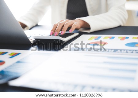 Business women reviewing data in financial statement. Accounting