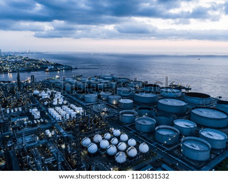 Aerial shooting of industrial areas and sea. Twilight.