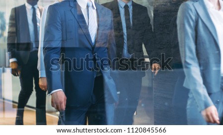 Diverse Team of Delegates/ Lawyers Led by Woman Confidently Marches Through the Corporate Building Hallway. Multicultural Crowd Of Resolute Business People in Stylish Marble and Glass Offices. Royalty-Free Stock Photo #1120845566