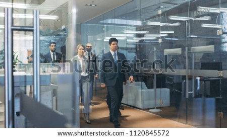 Diverse Team of Delegates/ Lawyers Confidently Marching Through the Corporate Building Hallway. Multicultural Crowd Of Resolute Business People in Stylish Marble and Glass Offices.