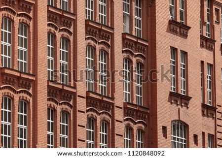 Windows in a multi-storey brick building as a background
