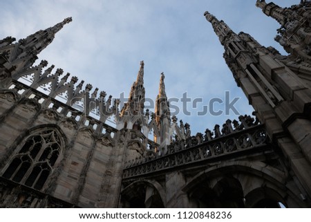 Rooftop of Duomo cathedral in Milan, Italy. Photo are taken during sunset time in winter with very warm and beautiful light. Duomo details and statues 
