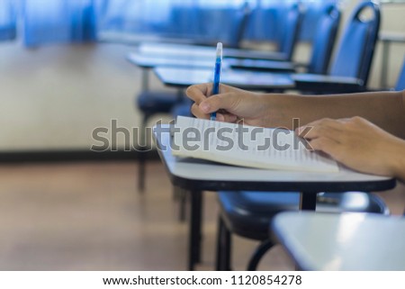 young student in the classroom closeup hands writing on notebook, About Learning and Teaching And to prepare for university entrance. Royalty-Free Stock Photo #1120854278